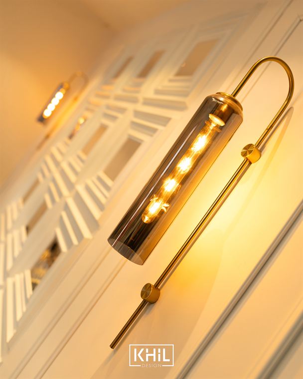 Brass wall light against panelled joinery, KHIL Design detail
